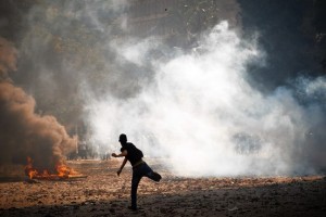 A protester in Cairo throws a rock at police as demonstrations over a video insulting the Prophet Muhammad continued. Egypt's president criticized the use of violence in the protests.